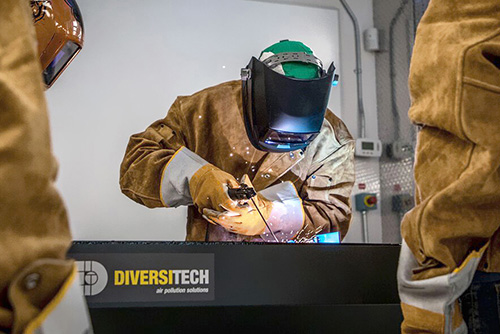 A welding student at Mohawk College using a Diversitech Downdraft Table