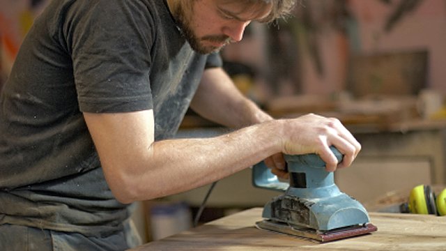 Carpenter Using An Electric Sander